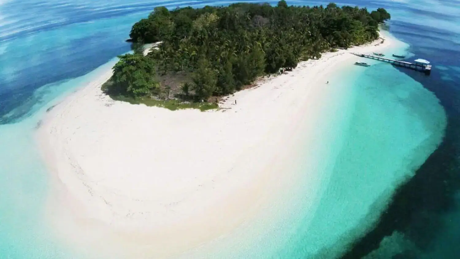 tiny island, white sand, lush greenery, crystal clear water, tropical paradise, remote location