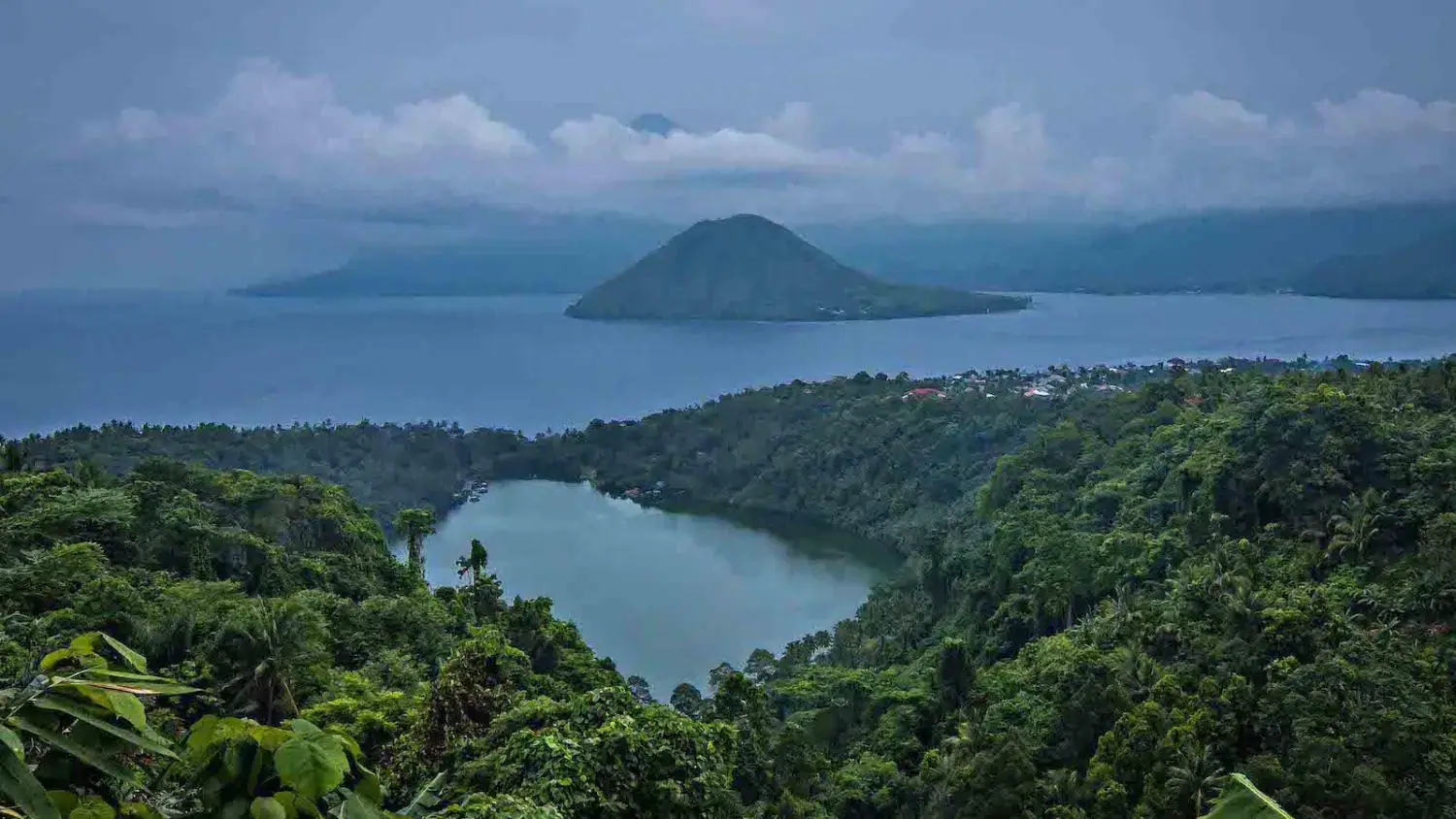 landscape view, lake, dense forest, distant islands, natural scenery, calm water, tropical vibes