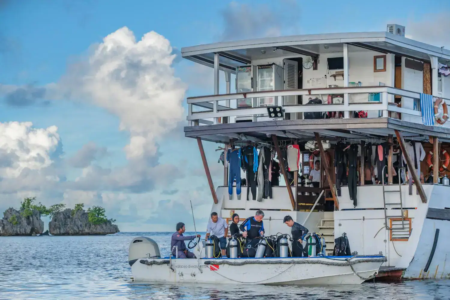 activity diving, diving preparation, onboard dive center, aft deck, zodiac, islands in the background