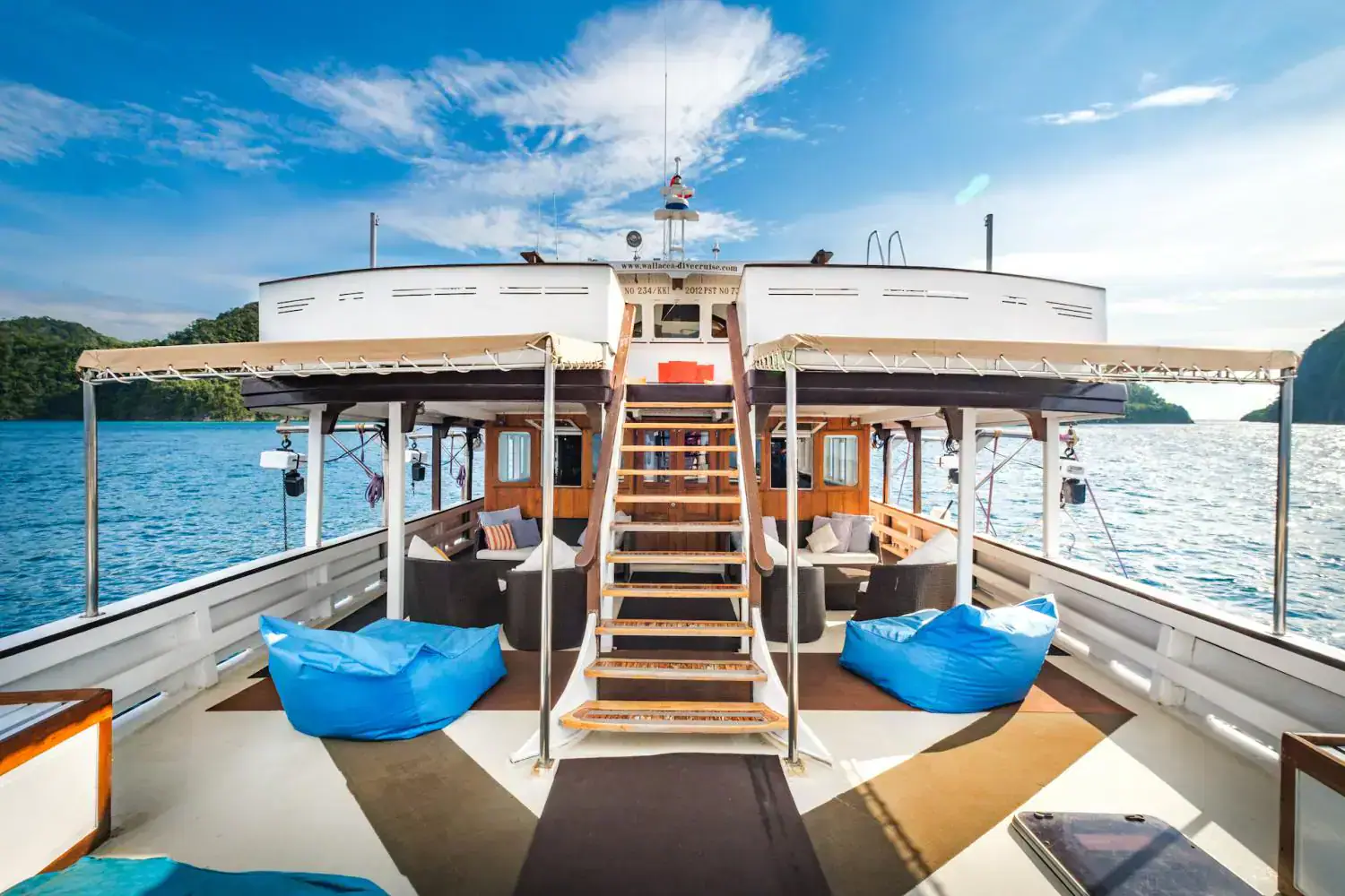 front lounge, sun spot, relaxing spot, blue ottomans, way to the upper deck, clear blue sky