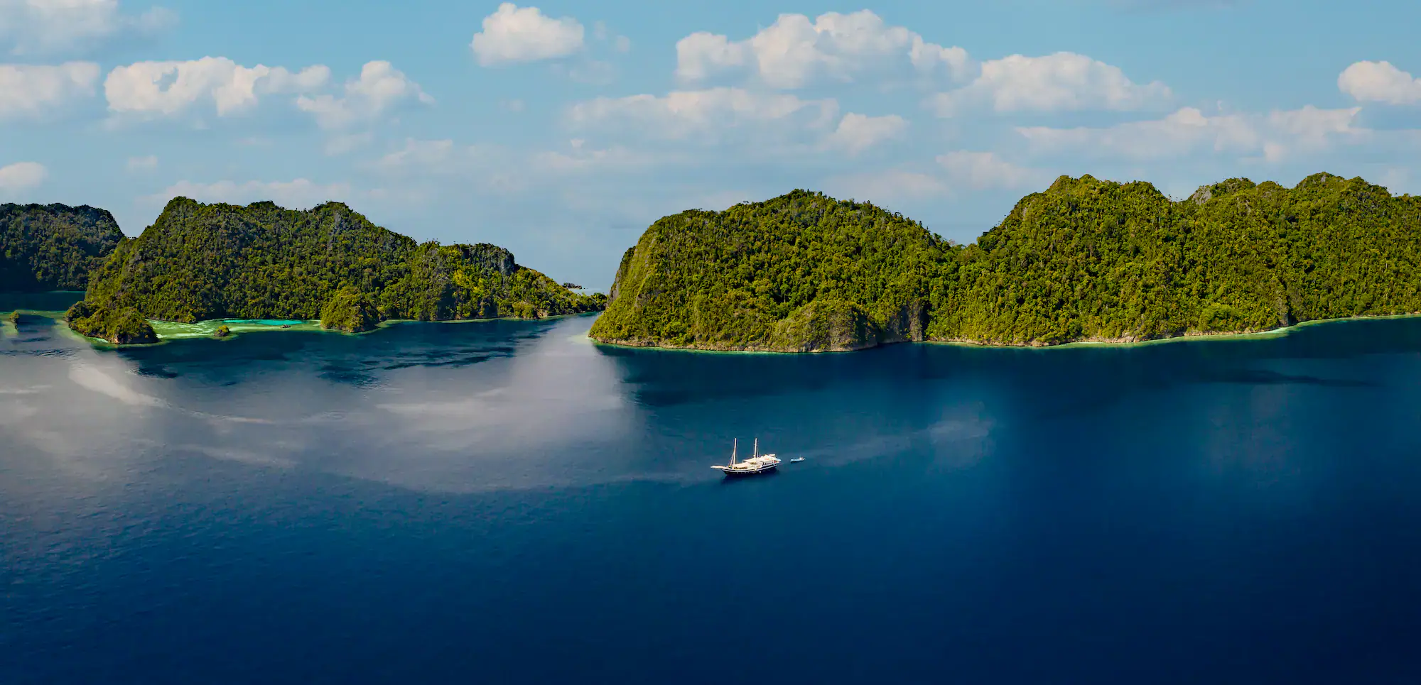 boat, blue water, green hills