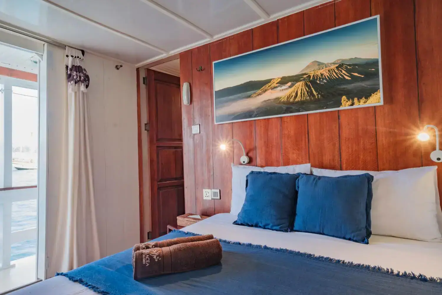 sea view cabin front, wooden wall, comfortable bed, sea view from the bed, clean room