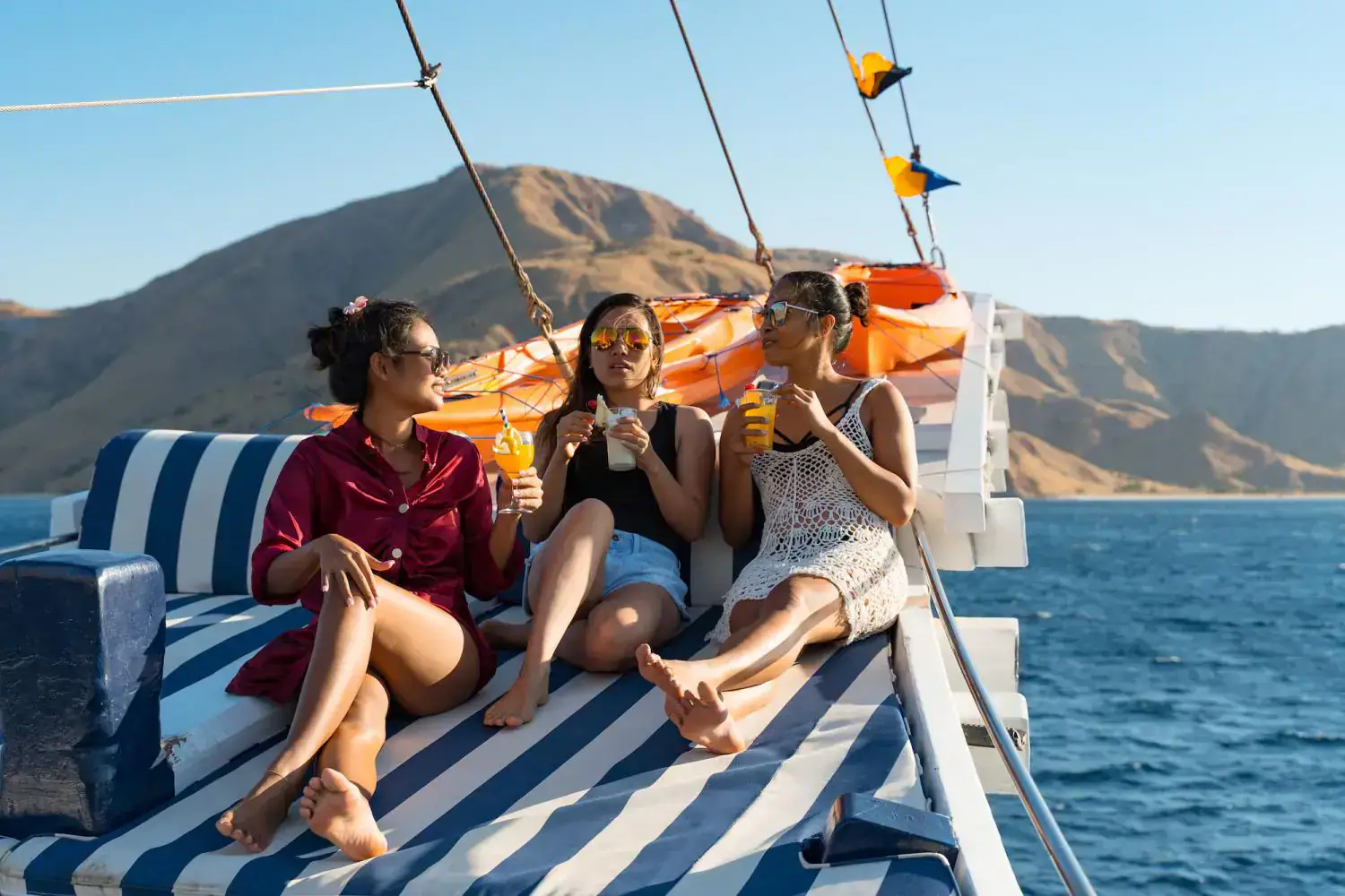 the main deck, relaxing spot, hills in the background, people enjoying, daybed