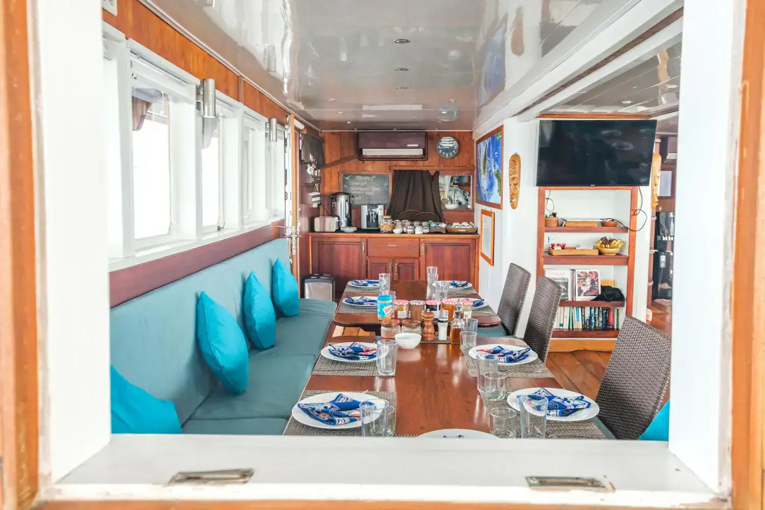 the restaurant b, blue sofa, dining table, indoor living area, boat interior