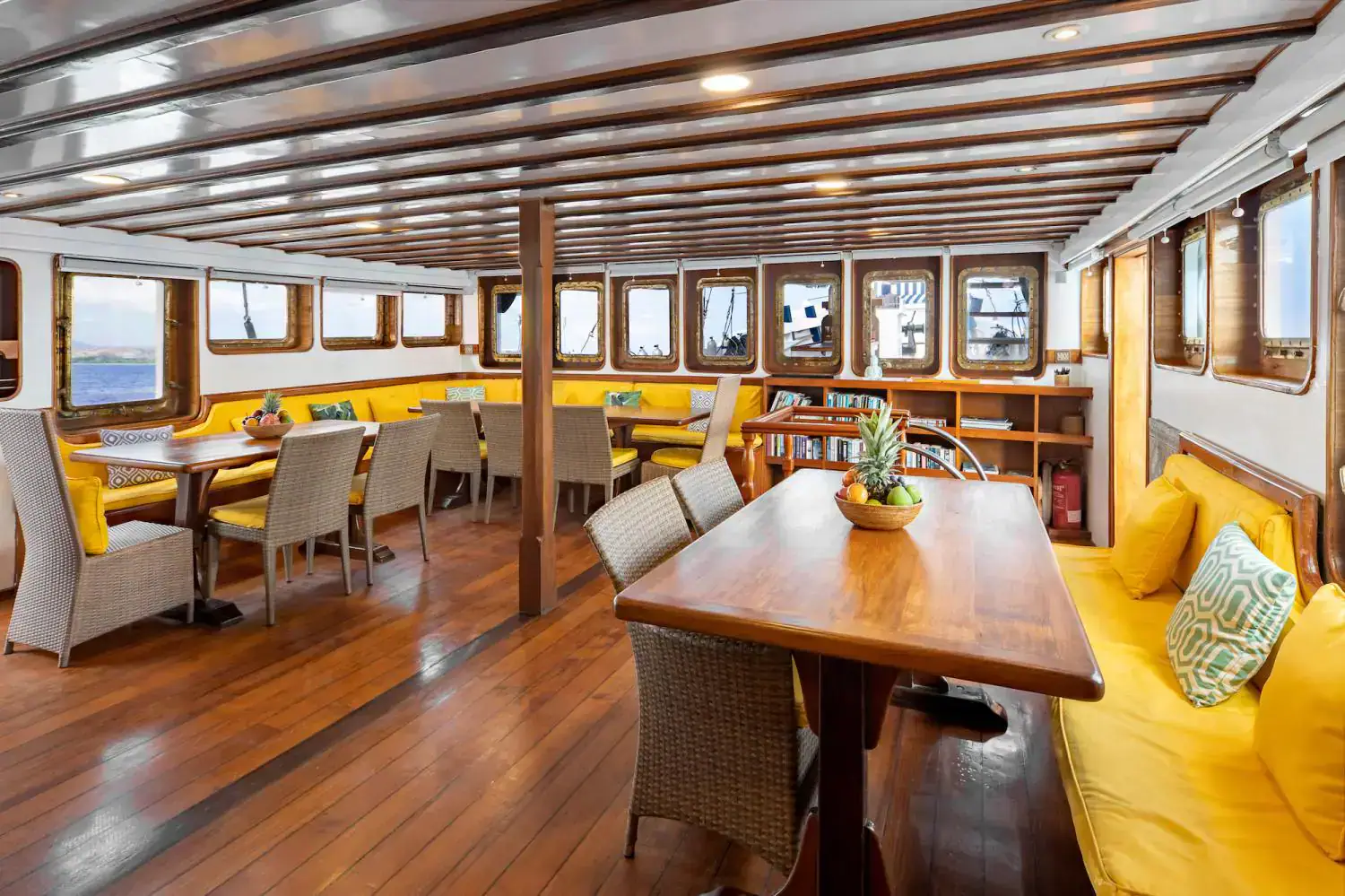 the restaurant, indoor living area, yellow bench, dinner tables, wooden interior